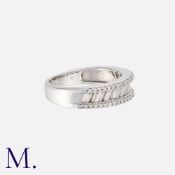 A Diamond Ring in 18K white gold, set with round and baguette-cut diamonds weighing approximately