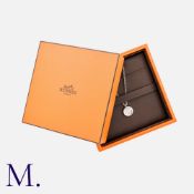 HERMES. A Clous de Selle Diamond Pendant & Chain in 18K white gold, set with a round-cut diamond