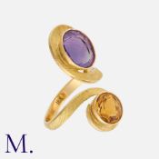 A Citrine and Amethyst Ring in 18K yellow gold, in a cross-over design with gold band finely-
