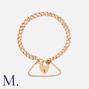 A Gold Curb Bracelet in 9ct rose gold, with heart padlock clasp and safety chain. Size: 19cm Weight: