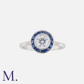 A Sapphire And Diamond Target Ring in 18k white gold, set with a central round cut diamond of