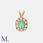 An Emerald and Diamond Pendant in 9K gold, set with an oval cut emerald to the centre with ten round