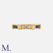 CARTIER. A Diamond and Sapphire Ring in 18K set with three round brilliant diamonds and six square