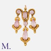 A Pink Topal Pendant in yellow gold, the art nouveau form set with faceted pink topaz suspending
