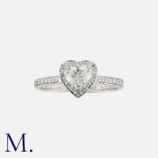 A Diamond Ring in 18k white gold, set with a heart shaped diamond of approximately 0.40cts, within a