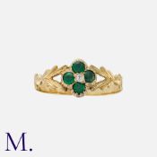 An Emerald And Diamond Ring in yellow gold, set with four round cut emeralds in quatrefoil form,