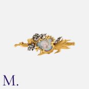 An Art Nouveau Portrait Miniature Brooch in 18K yellow gold, with portrait miniature to the centre