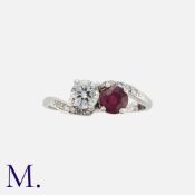 A Ruby and Diamond Toi et Moi Ring in platinum, set with a round cut diamond weighing approx. 0.60ct
