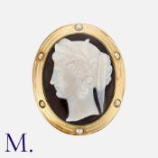 An Antique Hardstone Cameo Brooch with yellow gold mount. The sardonyx cameo depicts the Greek