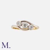 A Diamond Three Stone Ring in 18k yellow gold and platinum, of crossover design, set with three