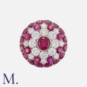 A Ruby and Diamond Retro Cluster Ring in platinum in a bombé cluster arrangement. Set with round cut