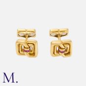 TIFFANY & CO. A Pair of Cufflinks in 18K yellow gold set with calibrated rubies with a geometric