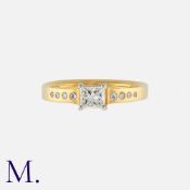 A Diamond Solitaire Ring in 18K yellow and white gold, set with a princess cut diamond weighing 0.