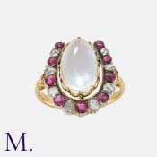 A Moonstone, Ruby And Diamond Horseshoe Ring in yellow gold and silver, comprising a horseshoe motif