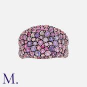 A Pink Sapphire Ring in 14k rose gold, set throughout with round cut pink sapphires. Marked 14k.