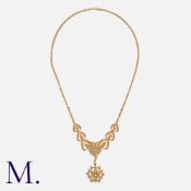 An Antique Seed Pearl Necklace in 15K gold. with heart motifs and star pendant. With antique box.