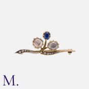 A Rose Cut Diamond And Sapphire Brooch in yellow gold, of foliate design, set with two large rose