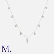 A Diamond Necklace in 18k white gold, the fine chain punctuated by round cut diamond drops, diamonds