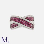 A Ruby and Diamond Crossover Ring in white and black gold, set with round cut rubies to a black gold