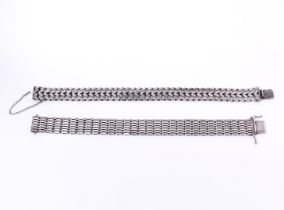 Two silver women's fantasy flat link bracelets, with a sliding clasp and safety chain
