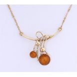 14 kt yellow gold necklace set with 2 round cabochon cut amber/amber