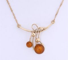 14 kt yellow gold necklace set with 2 round cabochon cut amber/amber