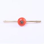 14 carat yellow gold women's brooch set with a cabochon cut red coral