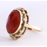 14 carat yellow gold ladies ring set with an oval cut faceted carnelian