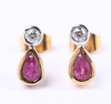 18 carat bicolor stud earrings, each set with an oval cut ruby and brilliant cut diamond