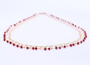 14 kt yellow gold wire necklace set with red crystal stones. Necklace length 41cm