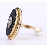 14 carat yellow gold Rococco ladies ring set with an oval cut onyx stone