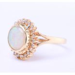 14 kt yellow gold entourage ring set with cabochon cut oval opal