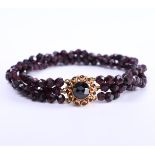 14 kt rose gold bracelet with 3 strands of faceted garnet beads