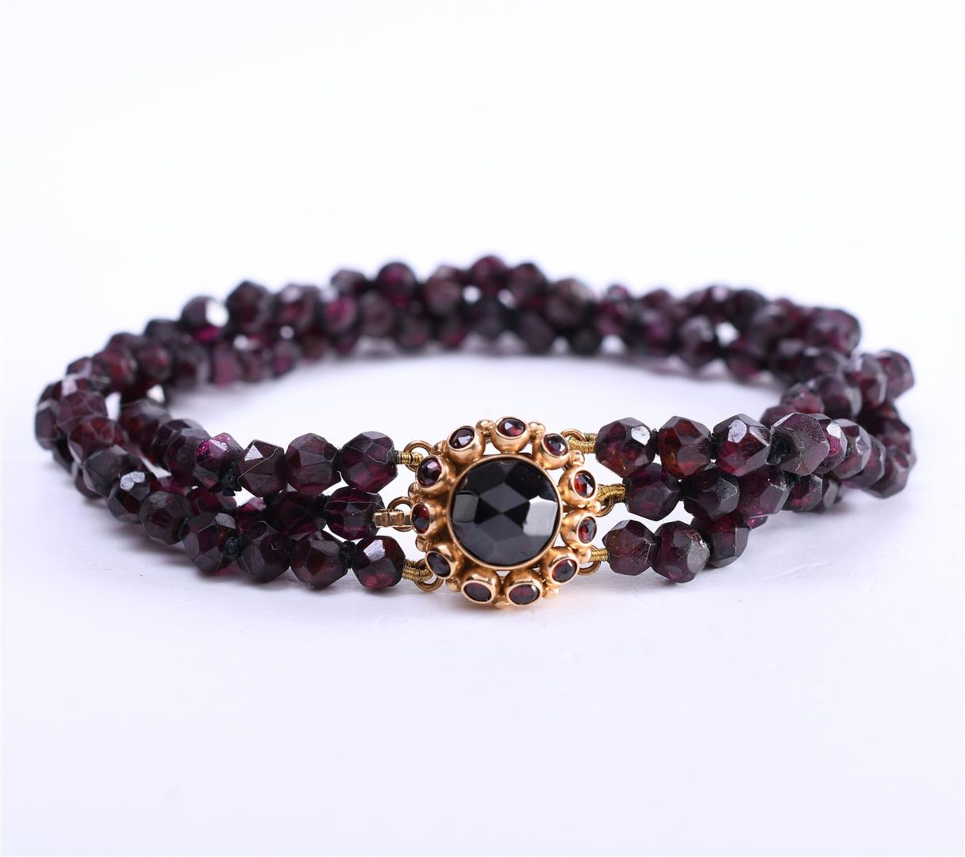 14 kt rose gold bracelet with 3 strands of faceted garnet beads