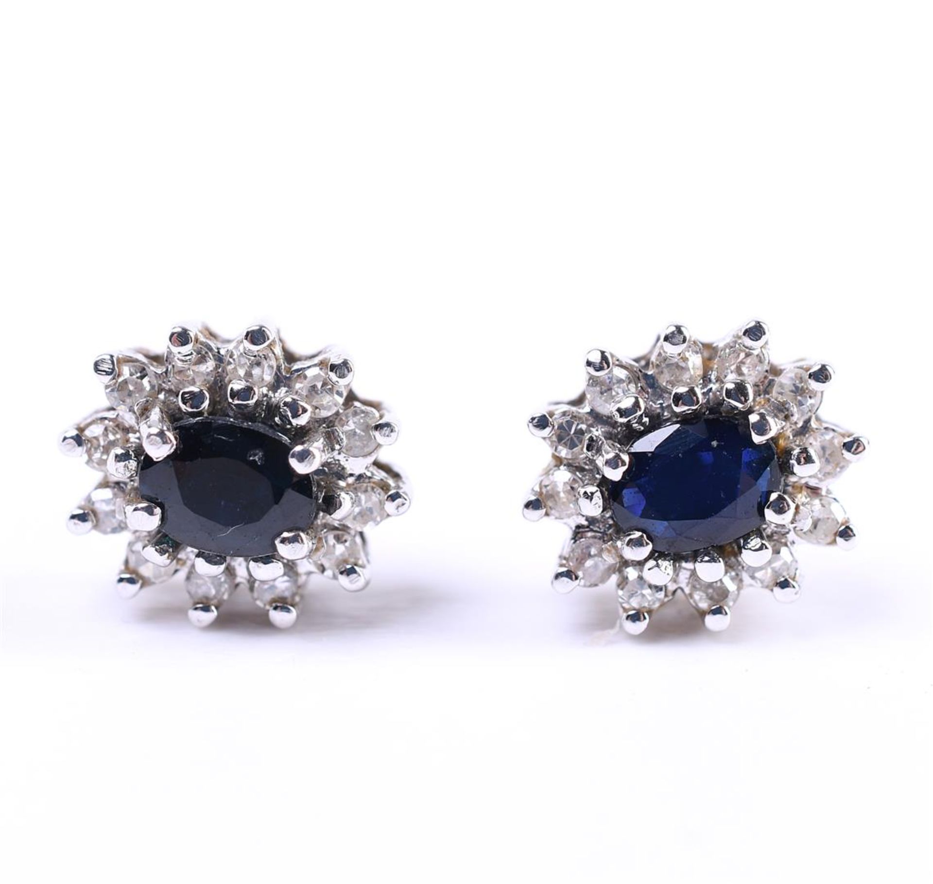 14 carat yellow gold women's entourage ear studs, each set with an oval cut blue sapphire 