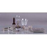 A lot with various silver objects including a spoon box, napkin rings and a scattering spoon.