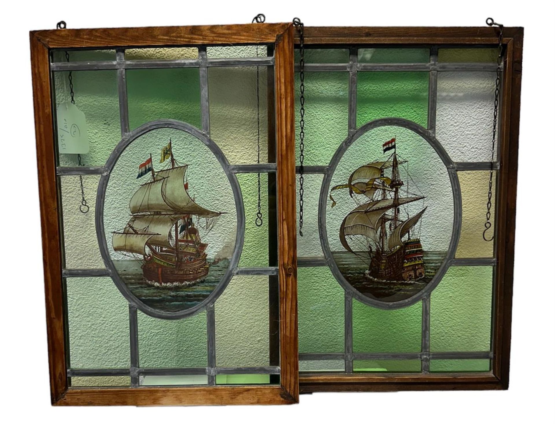 A lot consisting of (2) stained glass windows with stained glass depictions of ships. ca. 1930.
40 x