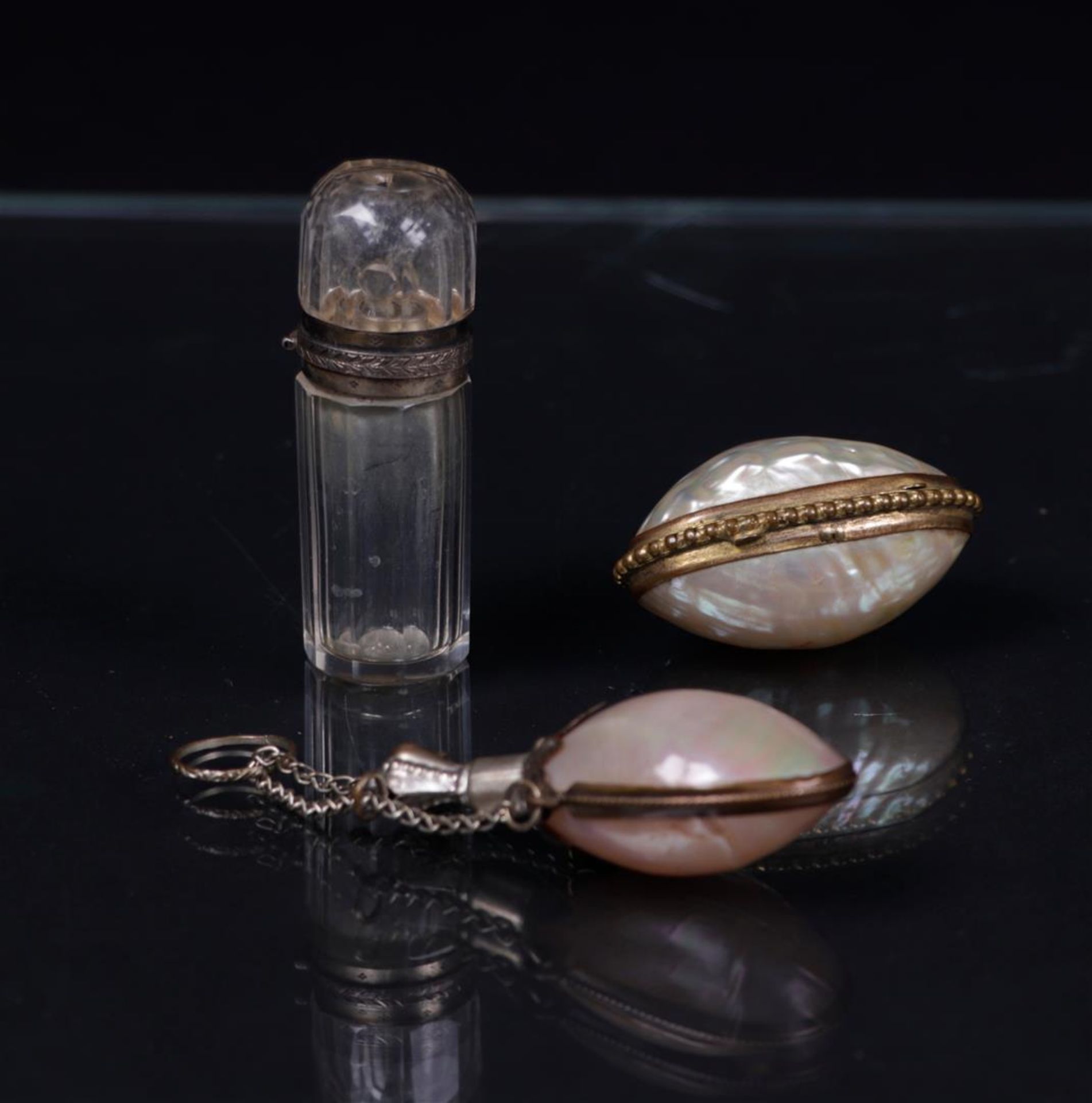 A lot consisting of (2) perfume bottles and a pill box, (2) of which are made of mother-of-pearl. Al