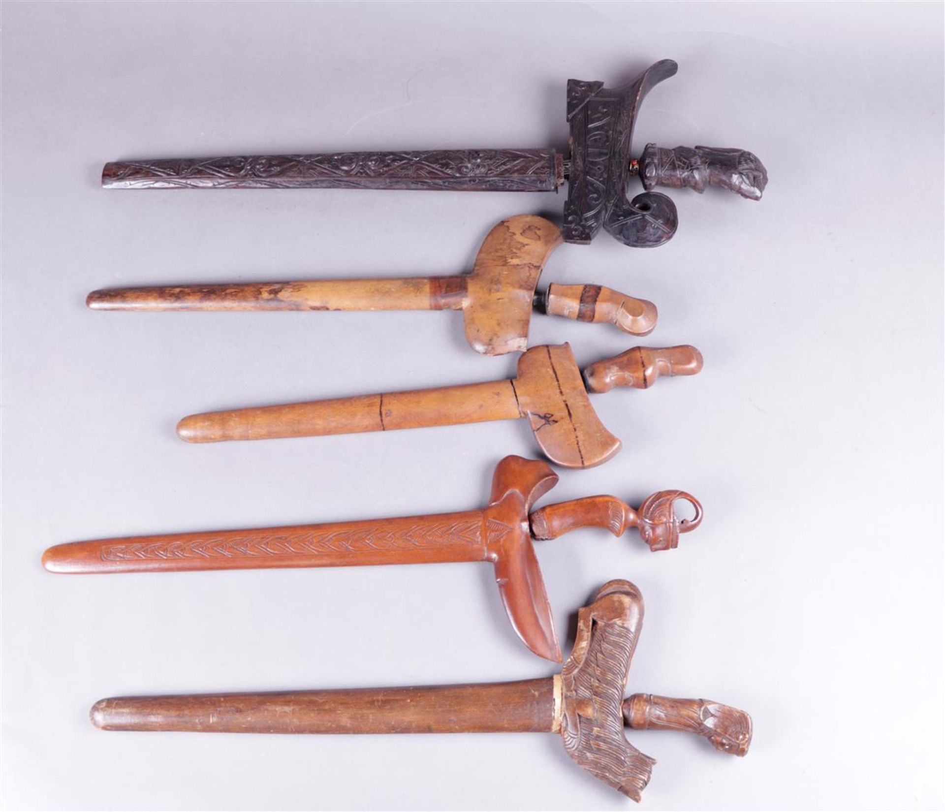 A lot of (5) various kris in decorated sheaths, Indonesia 19th century.