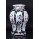 A very large famille rose lidded vase decorated with landscapes and antiques in beds, with floral de