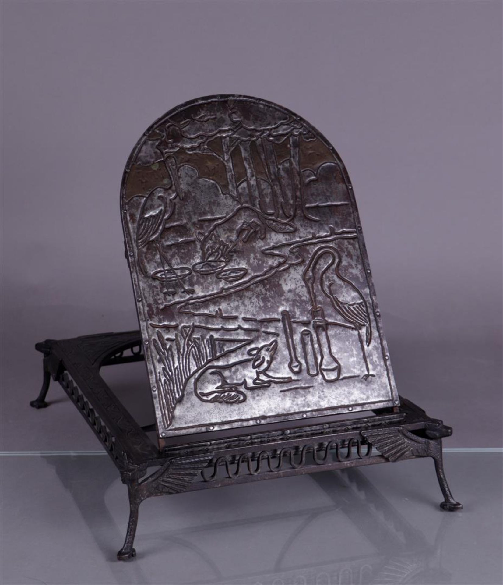 A wrought iron book stand depicting La Fontaine's Fable of the Fox and the Stork. ca. 1900.
43 x 32 