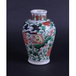 A porcelain Wucai vase decorated with dragons and flowers. China, transition.
H. 18 cm.