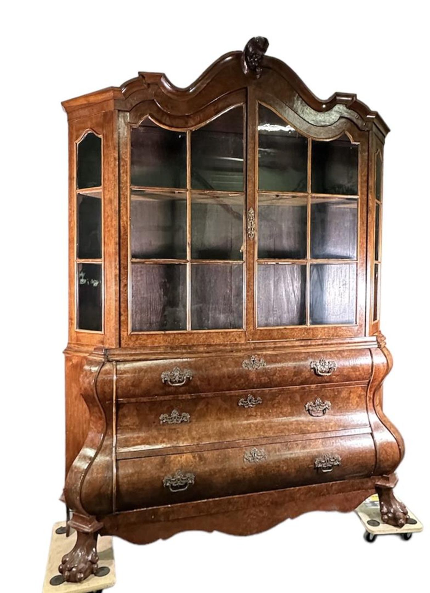 A Dutch mahogany glued display cabinet with a curved base cabinet on claw feet, the upper cabinet wi