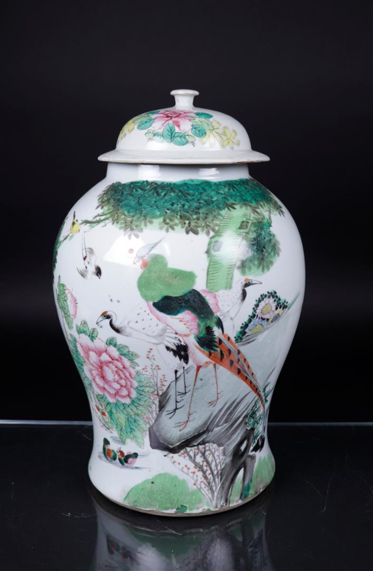 A porcelain Famille rose lidded vase decorated with various Chinese characters. China, 19th century.