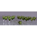A set of six and a set of eleven green crystal shot glasses.
H. 14 cm.