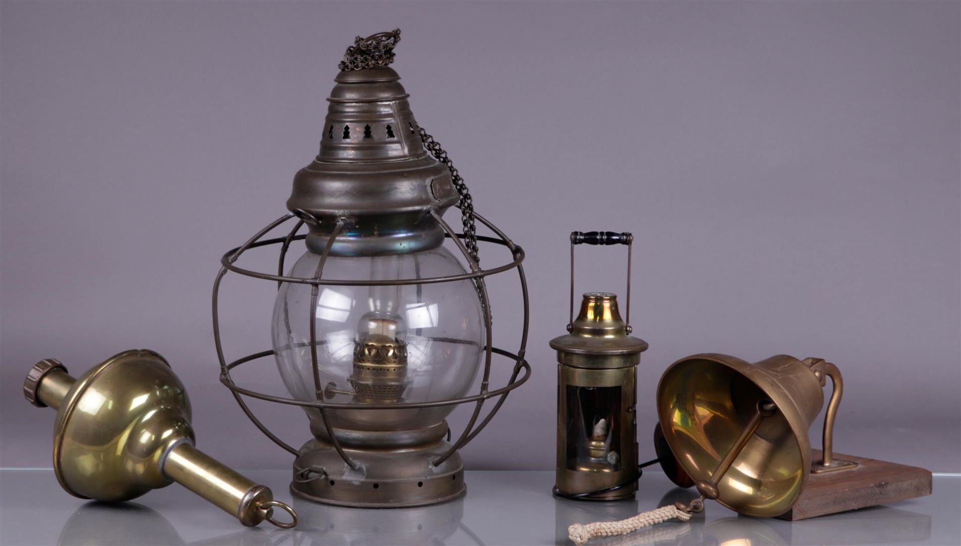 A lot of various ship lamps and a ship's bell.