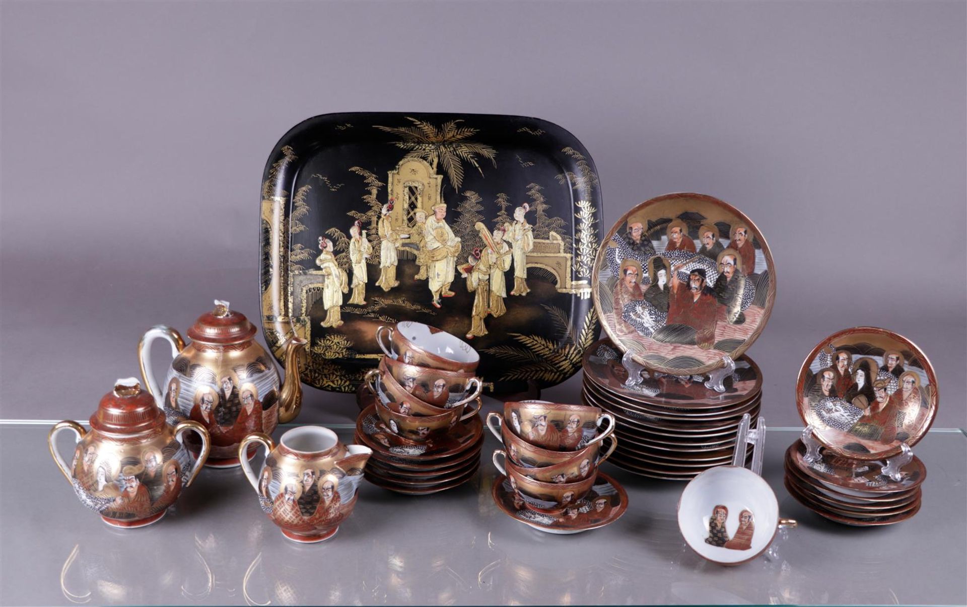 A Satsuma tea set with breakfast plates, plus a tray decorated with various figures. Japan, 19th cen