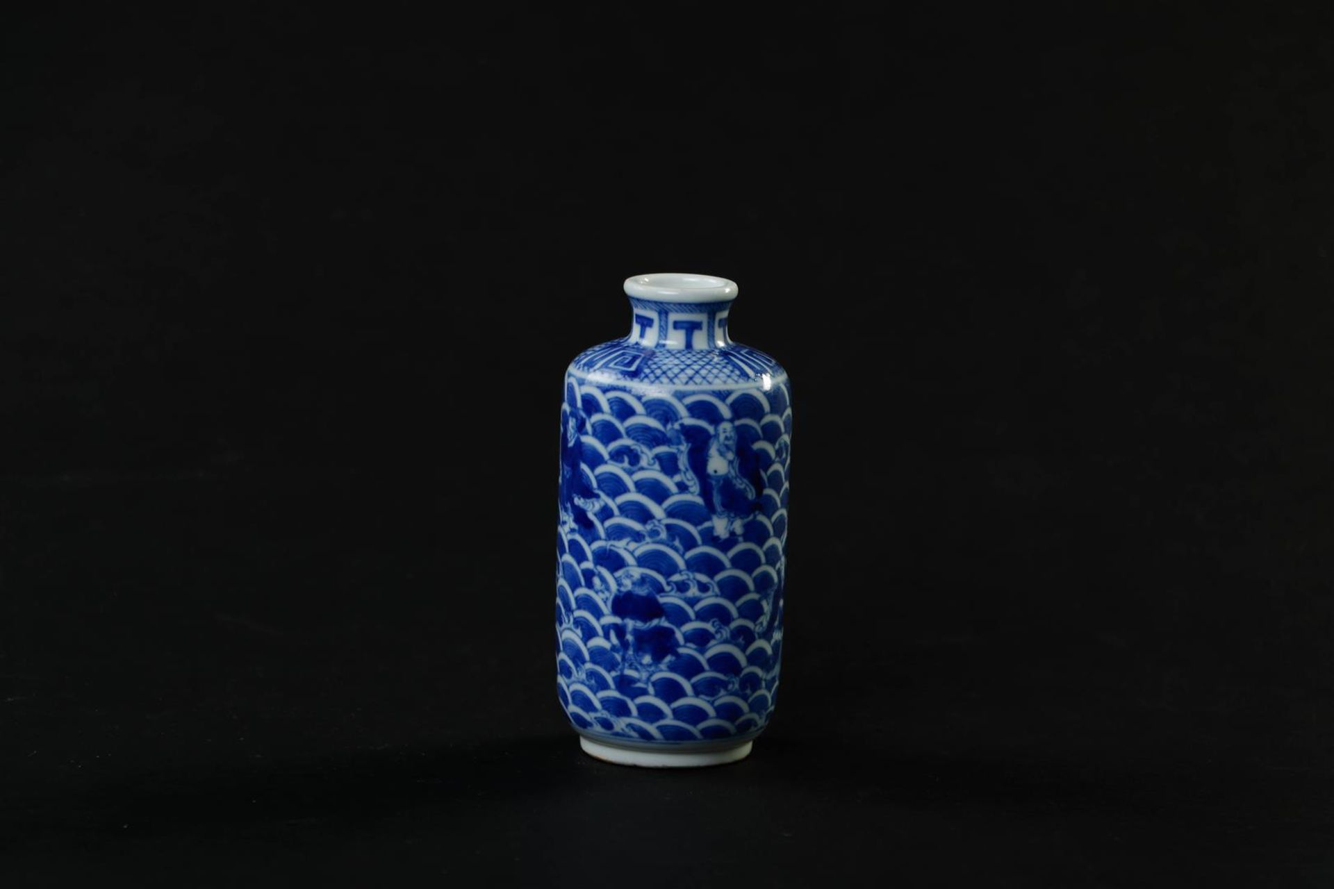 A porcelain cylindrical vase with a decor of figures in waves, marked Guanxu. China, 19th century.
H