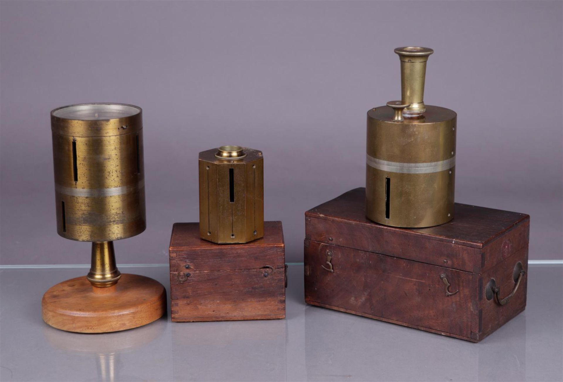 A lot of three antique surveyors, two of which are in a box.