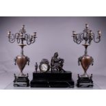 A large Garniture de CheminŽe consisting of a black marble mantel clock with a bell image of a poet,